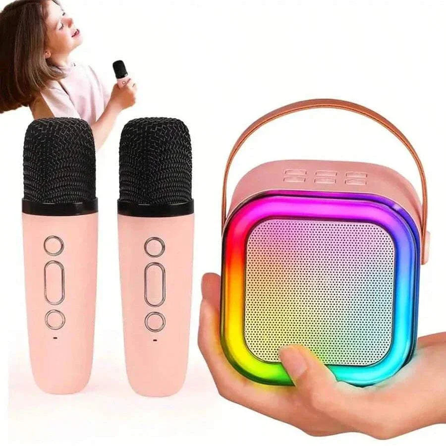 K12 Karaoke Machine with two wireless pink microphones and portable rainbow-colored speaker with leather handle